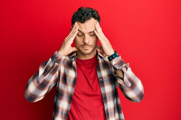 Young hispanic man wearing casual clothes with hand on head, headache because stress. suffering migraine.