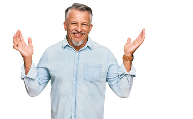 Middle age grey-haired man wearing casual clothes celebrating crazy and amazed for success with...
