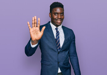 Handsome business black man wearing business suit and tie showing and pointing up with fingers number five while smiling confident and happy.