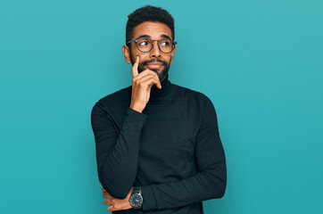 Young african american man wearing casual clothes serious face thinking about question with hand on...