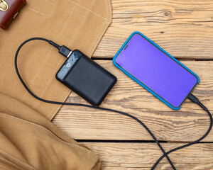 Charging the empty battery smartphone with power bank.