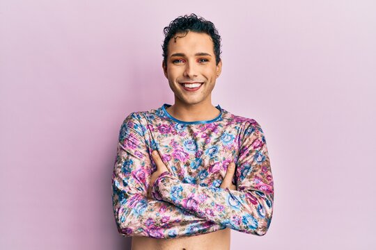 Handsome man wearing make up wearing fashion clothes happy face smiling with crossed arms looking at the camera. positive person.