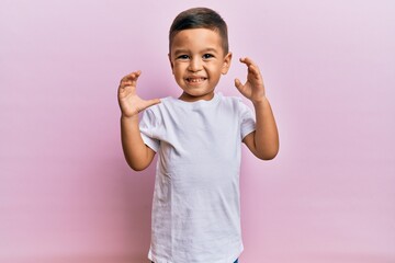 Adorable latin toddler holding ice cream looking positive and happy standing and smiling with a confident smile showing teeth