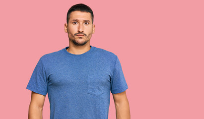 Fototapeta premium Handsome man with tattoos wearing casual clothes skeptic and nervous, frowning upset because of problem. negative person.