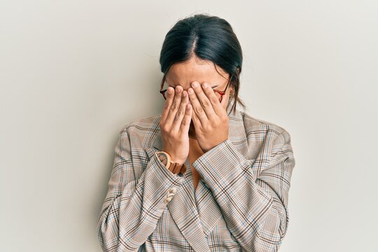 Young brunette woman wearing business jacket and glasses rubbing eyes for fatigue and headache, sleepy and tired expression. vision problem
