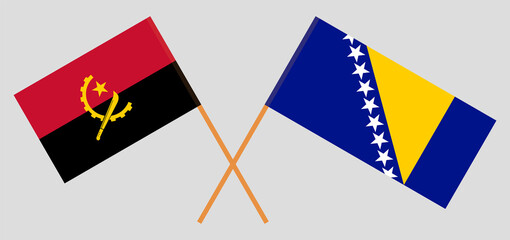 Crossed flags of Bosnia and Herzegovina and Angola. Official colors. Correct proportion