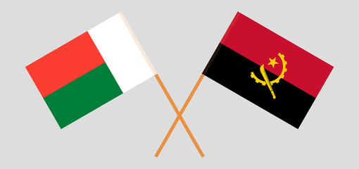 Crossed flags of Madagascar and Angola. Official colors. Correct proportion