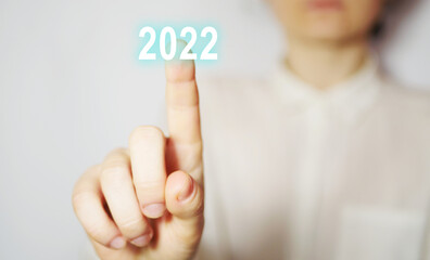 Faceless business woman touch 2022 number. New Year. Digital interface