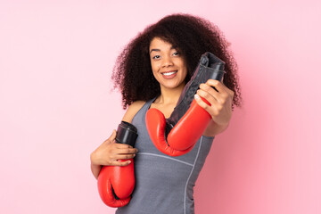 Young african american sport woman isolated on pink background with boxing gloves