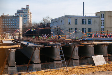 Workers in protective helmets are repairing bridge in Voronezh