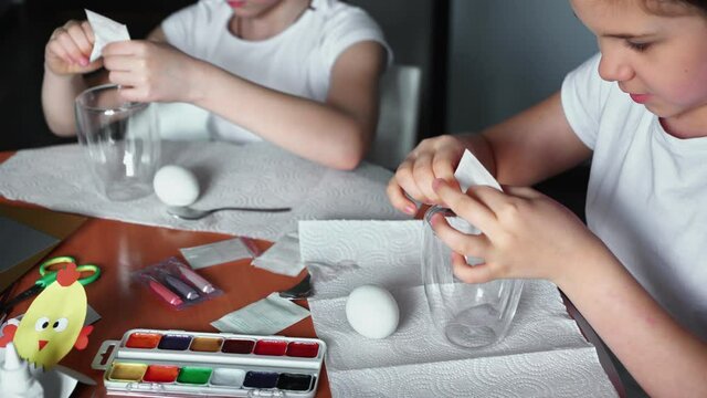 Happy easter. Two sisters painting Easter eggs. Happy family children preparing for Easter. Cute little child girl wearing bunny ears on Easter day.