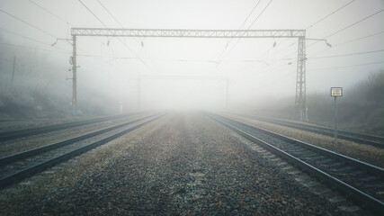 Railway tracks going into the fog.