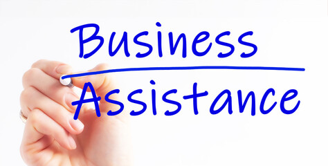 A hand with a marker writing 'business assistance'.