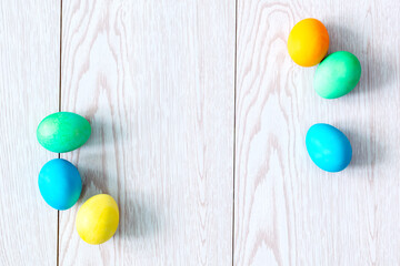 colorful easter eggs on wooden background with copy space flat lay, spring, easter concept frame