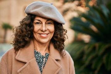 Middle age hispanic woman smiling happy standing at the city.