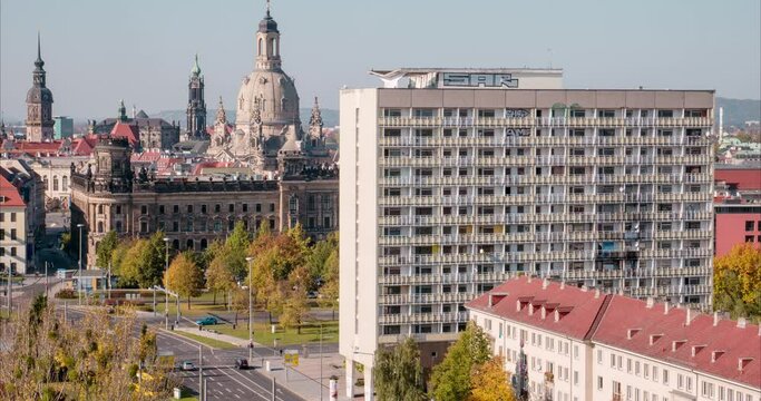 City life time lapse video with high rise buildings and the old town. Cityscape on a sunny day with cars moving on the street. Transportation in an urban area.