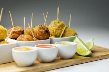Various mini chicken kievs and sweet potato falafels served with sauces