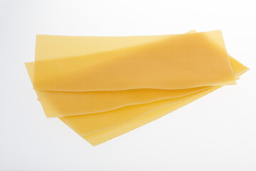 Uncooked lasagna sheets isolated on white