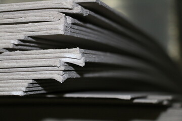 The gray cardboard that comes with the pallets used to make boxes in the printing house. selective focus is used.
