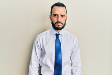 Young man with beard wearing business tie skeptic and nervous, frowning upset because of problem. negative person.