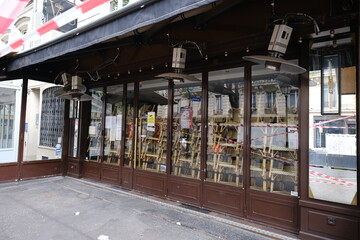 A restaurant closed in Paris during the coronavirus pandemic the 26th march 2021. A view of some chairs stacked in the showcase at a closed parisian restaurant.