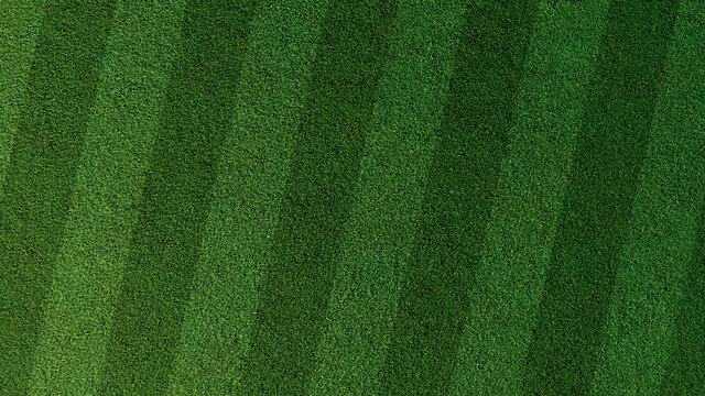 Green grass texture background. A perfectly manicured Sports field / Pitch / Garden Lawn wallpaper with stripes.