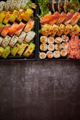 Sushi take-away plastic tray with diffent kinds of rolls and copy space. Take-away food concept.