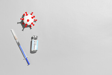 Fototapeta na wymiar Coronavirus vaccination concept. Ampoule with vaccine against COVID-19, medical syringe, and white ball in form virus on gray background. Top view, empty place for text