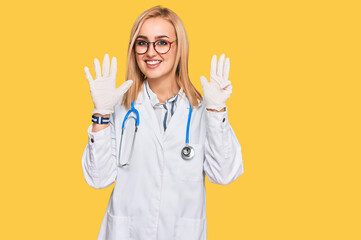 Beautiful caucasian woman wearing doctor uniform and stethoscope showing and pointing up with...