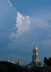 Fototapeta na wymiar A cloud in the form of a white dove, pigeon in the sky above the Kiev-Pechersk Lavra in Kiev 