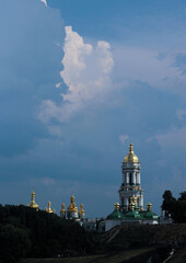 Fototapeta na wymiar A cloud in the form of a white dove, pigeon in the sky above the Kiev-Pechersk Lavra in Kiev 