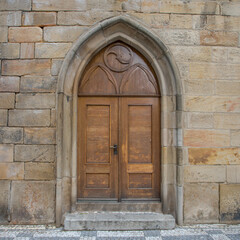 Fototapeta na wymiar old wooden door in wall - charles bridge, prague