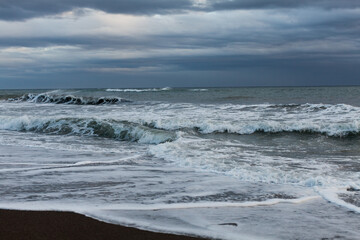 Seascape of the Mediterranean sea after a storm, surfers practicing bodyboar on the waves