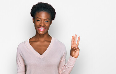 Young african american girl wearing casual clothes showing and pointing up with fingers number three while smiling confident and happy.