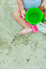 Dnipro, Ukraine: 12.08.2015; The  baby saeting on the sand beach