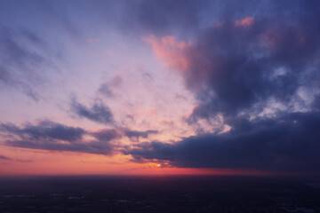 Aerial view of an orange or pink sky, a beautiful sunset, the clouds are highlighted with bright light.Evening time.