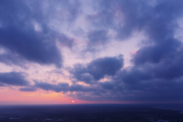 Aerial view of an orange or pink sky, a beautiful sunset, the clouds are highlighted with bright light.Evening time.