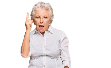 Senior grey-haired woman wearing casual clothes pointing finger up with successful idea. exited and happy. number one.