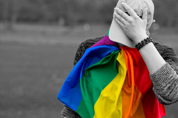 Lgbt flag, gey. A person ashamed of their sexual orientation. A black and white photograph with a...