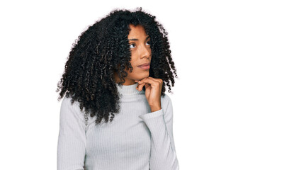 Fototapeta na wymiar Young african american girl wearing casual clothes with hand on chin thinking about question, pensive expression. smiling and thoughtful face. doubt concept.