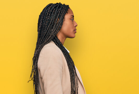 African American Woman Wearing Business Jacket Looking To Side, Relax Profile Pose With Natural Face And Confident Smile.