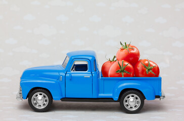 Toy pickup truck delivering  red tomatoes 