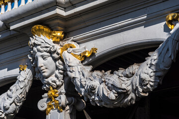 Fototapeta premium A sculpture of a women's face adorns the Beau Art Pont Alexander III bridge in Paris France.