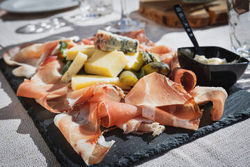 Plate of speck and typical italian salami with cheese and pickles, Cortina D'Ampezzo, Italy
