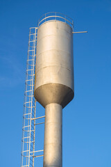 Water tower on a background of blue clear sky