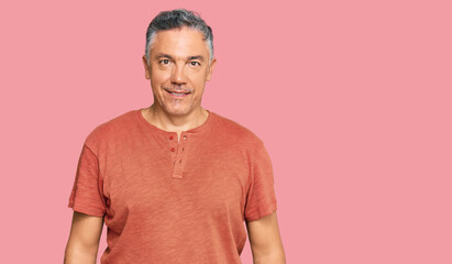 Obraz premium Handsome middle age man wearing casual clothes with a happy and cool smile on face. lucky person.
