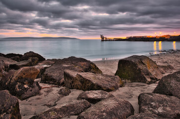 Beautiful sunset scenery with dramatic cloudy skies over Blackrock at Salthill beach in Galway, Ireland 