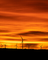 Fototapeta na wymiar wind turbine silhouettes in a cloudy sunset