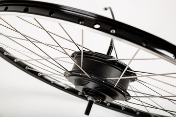 Electric motor on a bicycle wheel. White background.