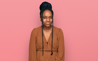 Young african american woman wearing casual clothes skeptic and nervous, frowning upset because of...